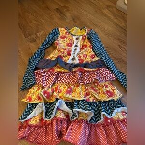 Mustard Pie Reagan Apron Dress with a floral and chevron pattern size 8 girls.